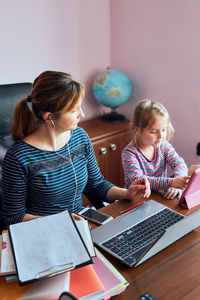 Woman using laptop on table at home