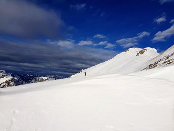 Scenic view of snow covered mountains against sky