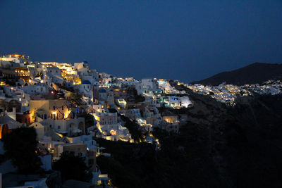 High angle view of illuminated cityscape against clear sky