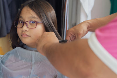 Portrait of smiling girl holding eyeglasses