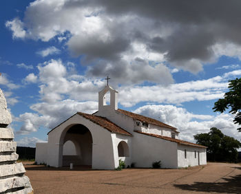 Low angle view of building against cloudy sky