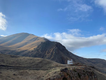 Scenic view of mountains against cloudy sky