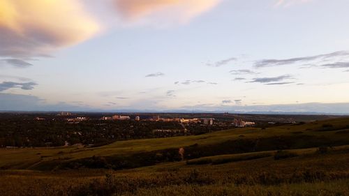 Scenic view of field against sky at sunset