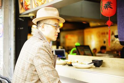 Side view of man preparing food at restaurant