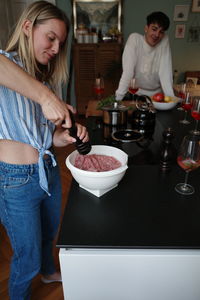 Full length of a woman standing at table