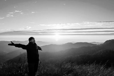 Full length of man standing on mountain against sky