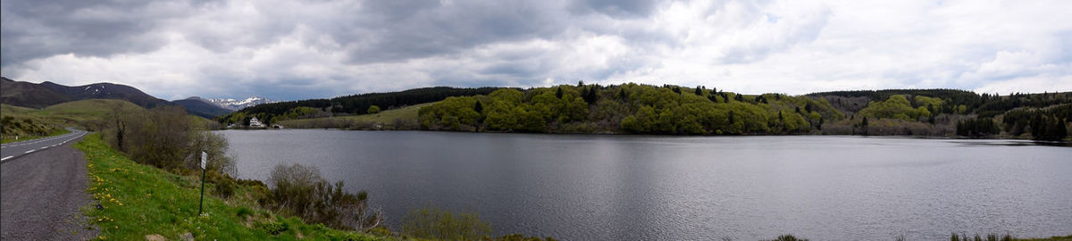 Panoramic view of river amidst trees against sky