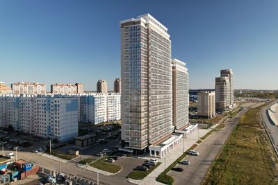 Buildings in city against clear sky