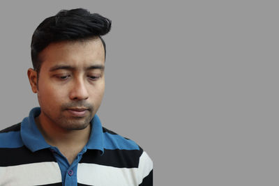 Portrait of young man against white background