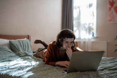 Young woman using laptop at home