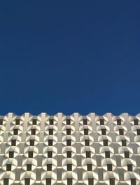 Low angle view of built structure against clear blue sky