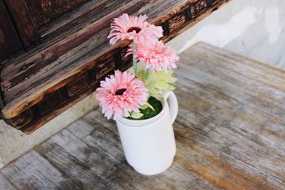 High angle view of pink flower pot on table