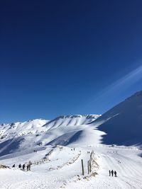 Scenic view of snowcapped mountain against blue sky