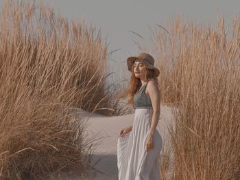 Full length of young woman standing on land