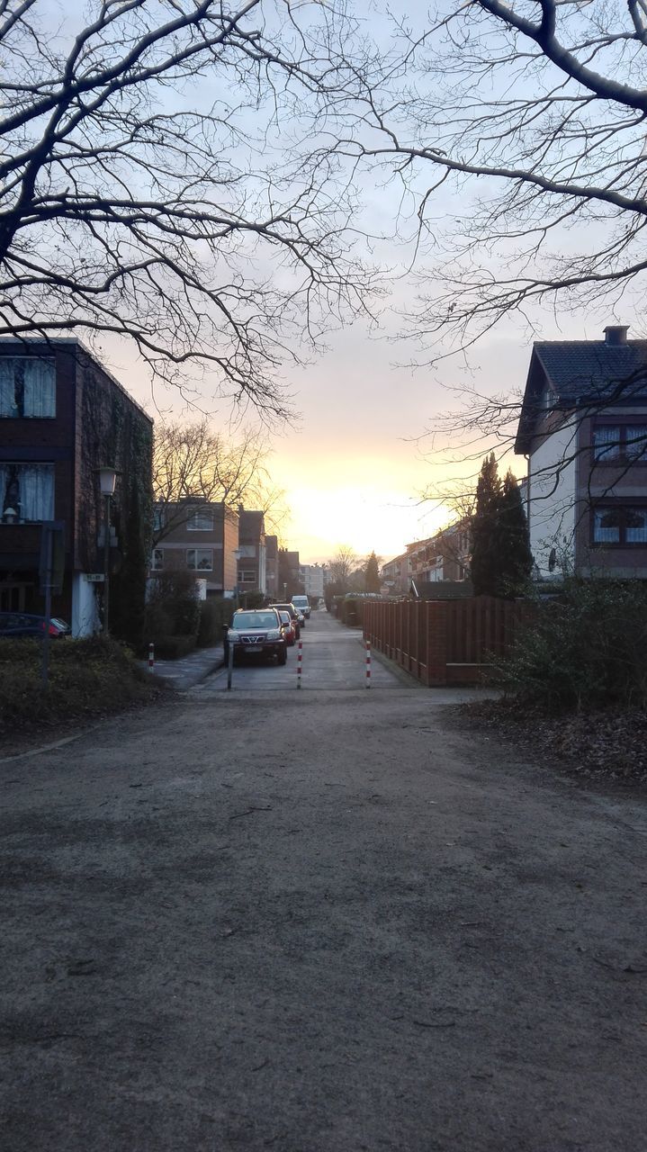 CARS ON STREET AGAINST SKY