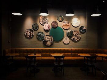 Empty chairs and table against wall