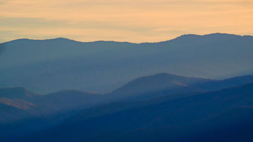 Scenic view of silhouette mountains against sky during sunset