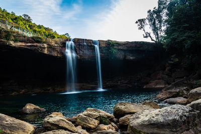 Waterfall streams falling from mountain top at morning long exposure shot from different angle