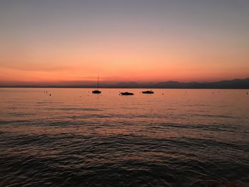 Scenic view of sea against orange sky