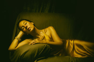 Woman with yellow dress lying in a chair v