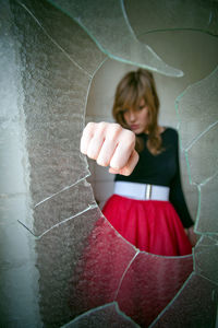 Angry woman breaking glass