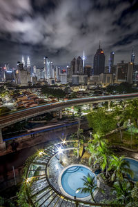 High angle view of illuminated buildings in city at night