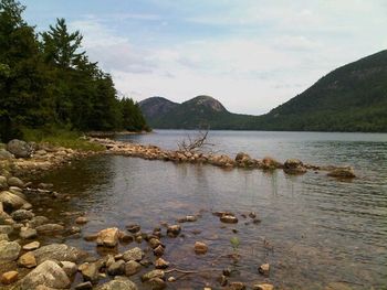 Scenic view of lake against cloudy sky