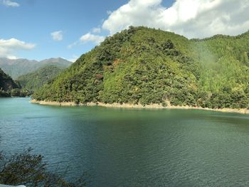 Scenic view of lake and mountains against sky