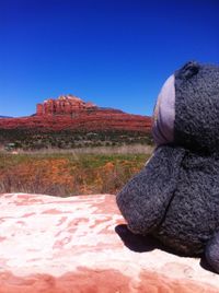 Scenic view of desert against clear blue sky