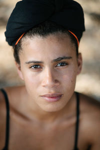 Close-up portrait of young woman with headscarf