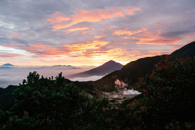 Scenic view of mountains against cloudy sky