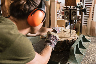 Rear view of man working in machine