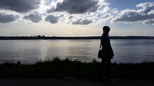 Silhouette of woman standing by sea