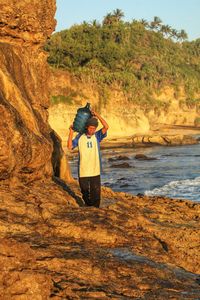 Rear view of man standing on shore