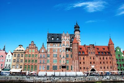 Low angle view of buildings against blue sky