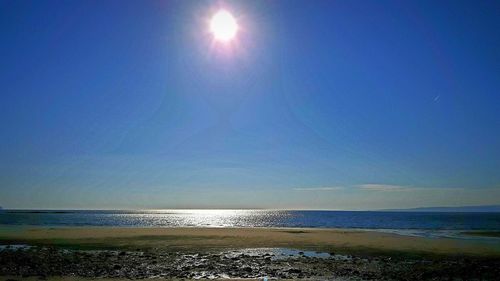 View of beach against blue sky