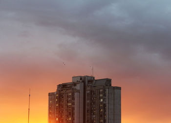 Low angle view of buildings against sky during sunset