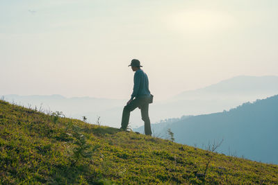 Hiker man relax and yoga exercise with wellbeing and happy feeling on top of mountain