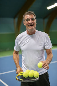 Smiling man on tennis court