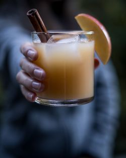 Close-up of hand holding juice in glass