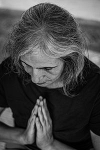 High angle view of woman praying while sitting in temple