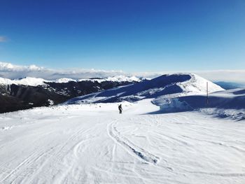 Scenic view of snowcapped mountains against clear blue sky