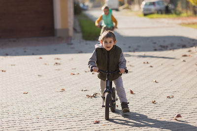 Portrait of cute girl riding bicycle on street