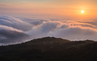 Scenic view of dramatic sky over landscape during sunset