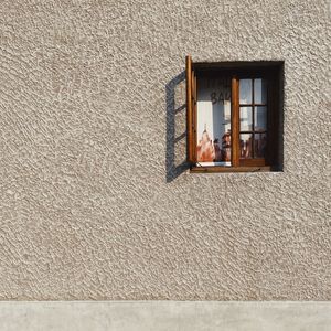 Low angle view of window on wall of building