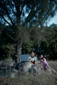 People sitting on street in forest