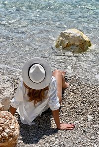High angle view of woman wearing hat at beach