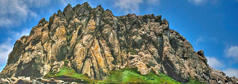 Low angle view of rock formation against sky