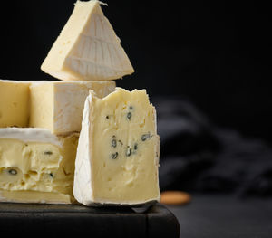 Brie and bergader blue cheese on a brown wooden board, delicious snack