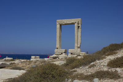 Built structure on beach against clear blue sky